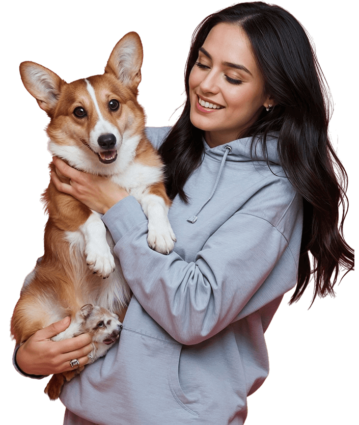 Uśmiechnięta właścicielka trzyma psa rasy corgi - opieka weterynaryjna MultiVet Lutynia